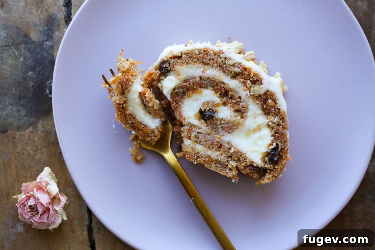Spiced Carrot Cake Swirl 3 A close-up shot of a carrot cake roll, showcasing the swirls of cake and cream cheese frosting, with a warm, inviting glow.