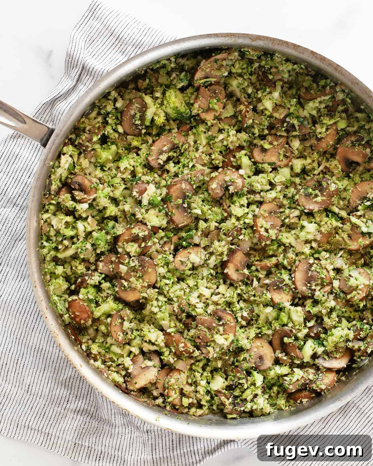 Balsamic Glazed Mushroom and Broccoli Rice 2 A large skillet filled with delicious balsamic mushroom broccoli rice, garnished with fresh herbs.