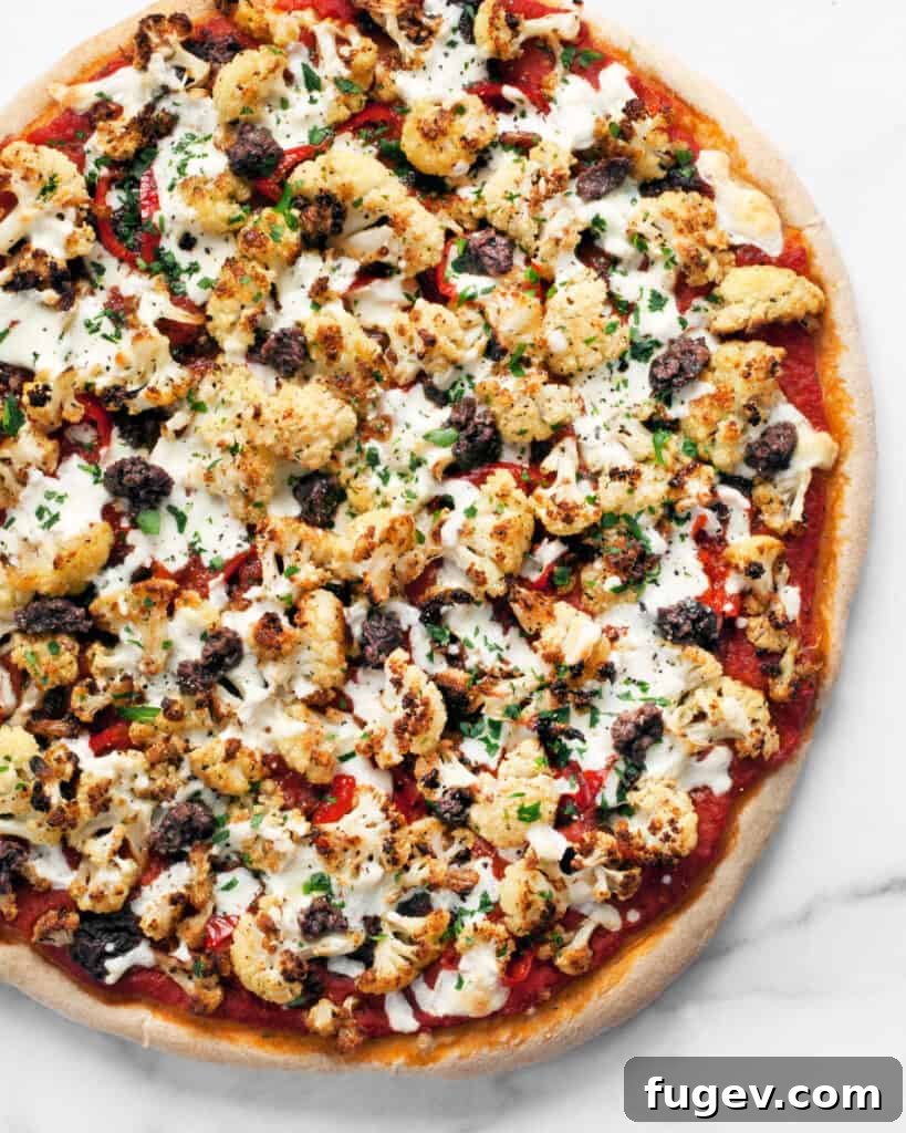 Golden Roasted Cauliflower Tapenade Pizza 5 A delicious slice of Roasted Cauliflower Olive Tapenade Pizza ready to be served