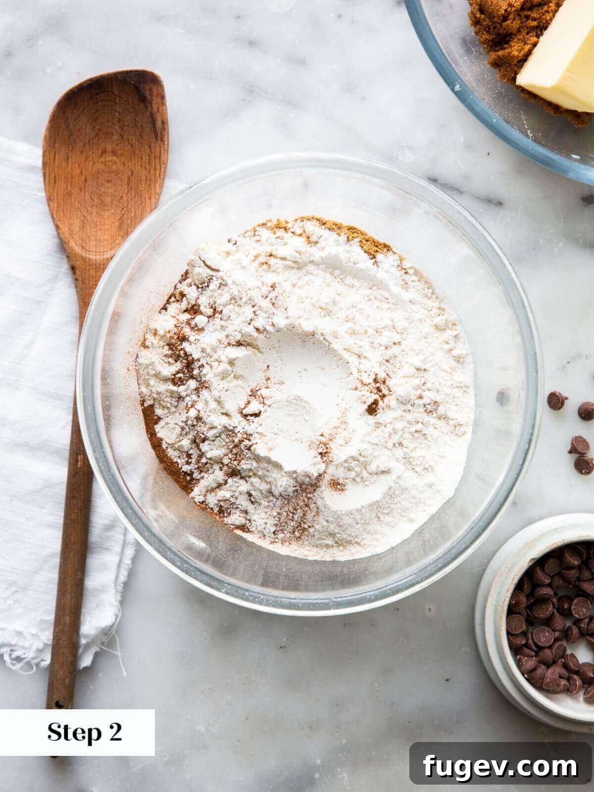Spiced Pumpkin Chocolate Delights 5 A bowl filled with the sifted dry ingredients for pumpkin chocolate chip cookies, including flour and a blend of warm spices, ready for mixing.