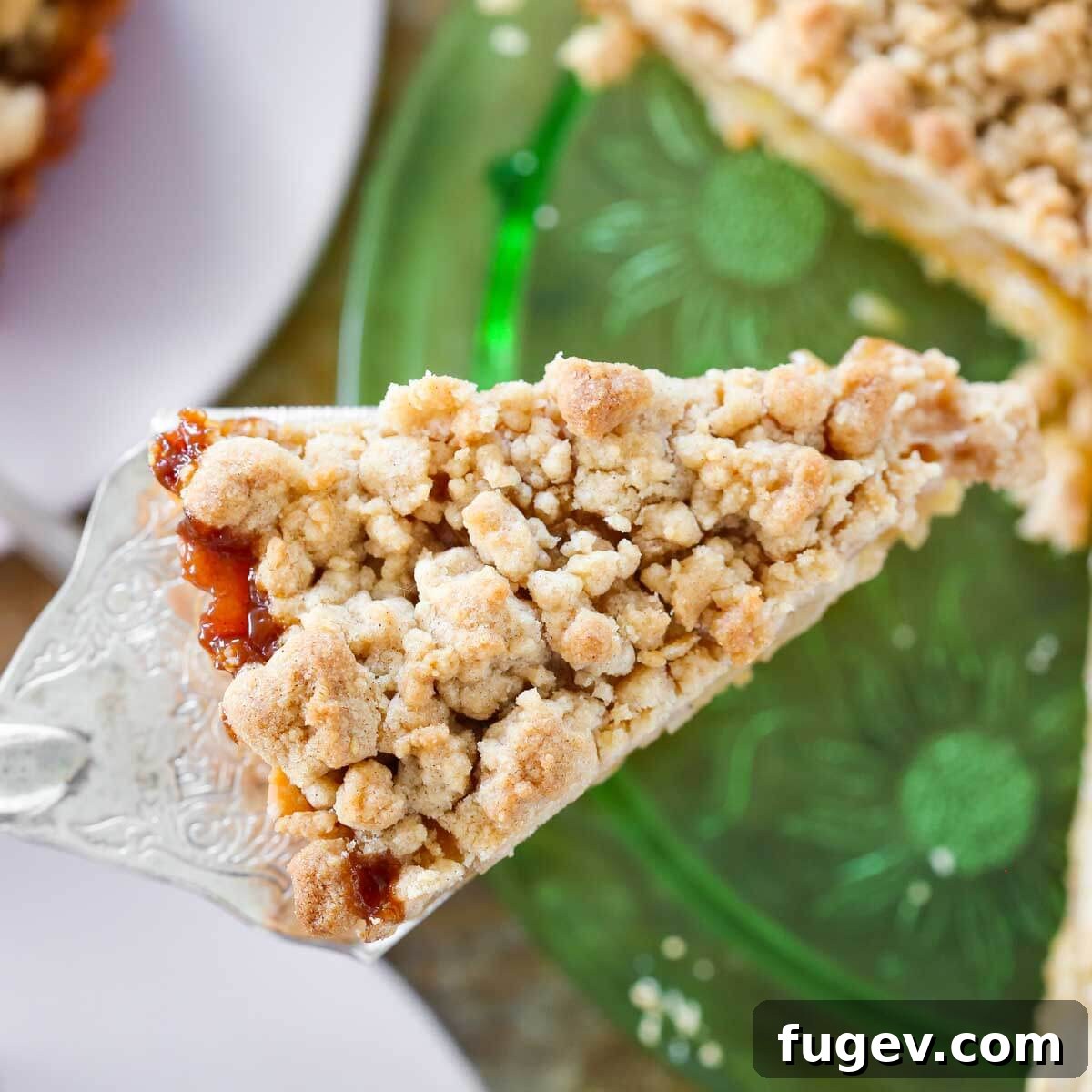Buttery Crumb Topping 3 A slice of apple tart generously topped with golden brown streusel, showcasing its inviting texture.