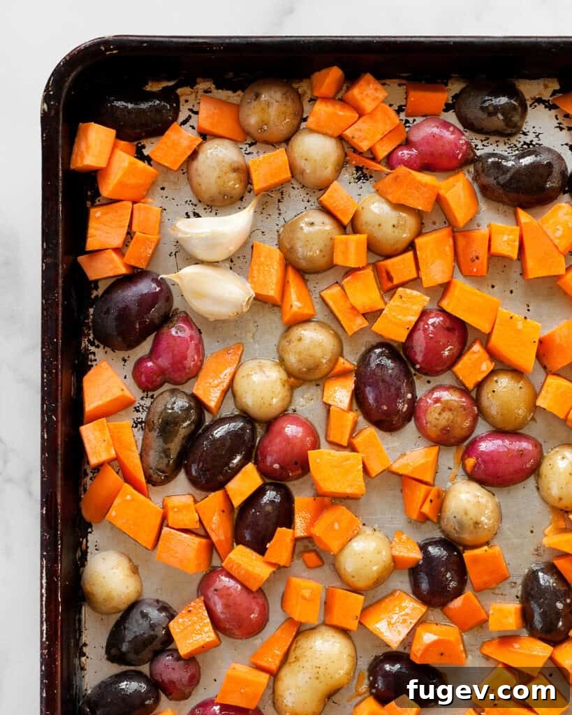 Golden Roasted Potato and Brussels Sprout Salad 5 Halved new potatoes and diced sweet potatoes seasoned on a sheet pan, ready for roasting