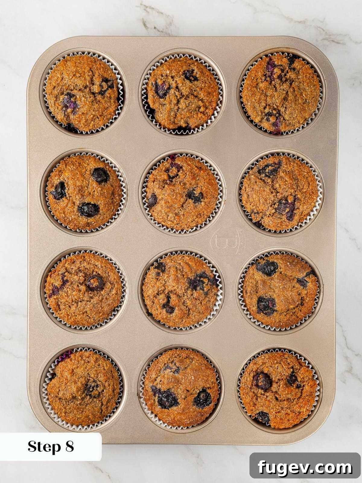 Fiber-Rich Banana Muffins 14 Freshly baked banana bran muffins cooling in a metal muffin pan.