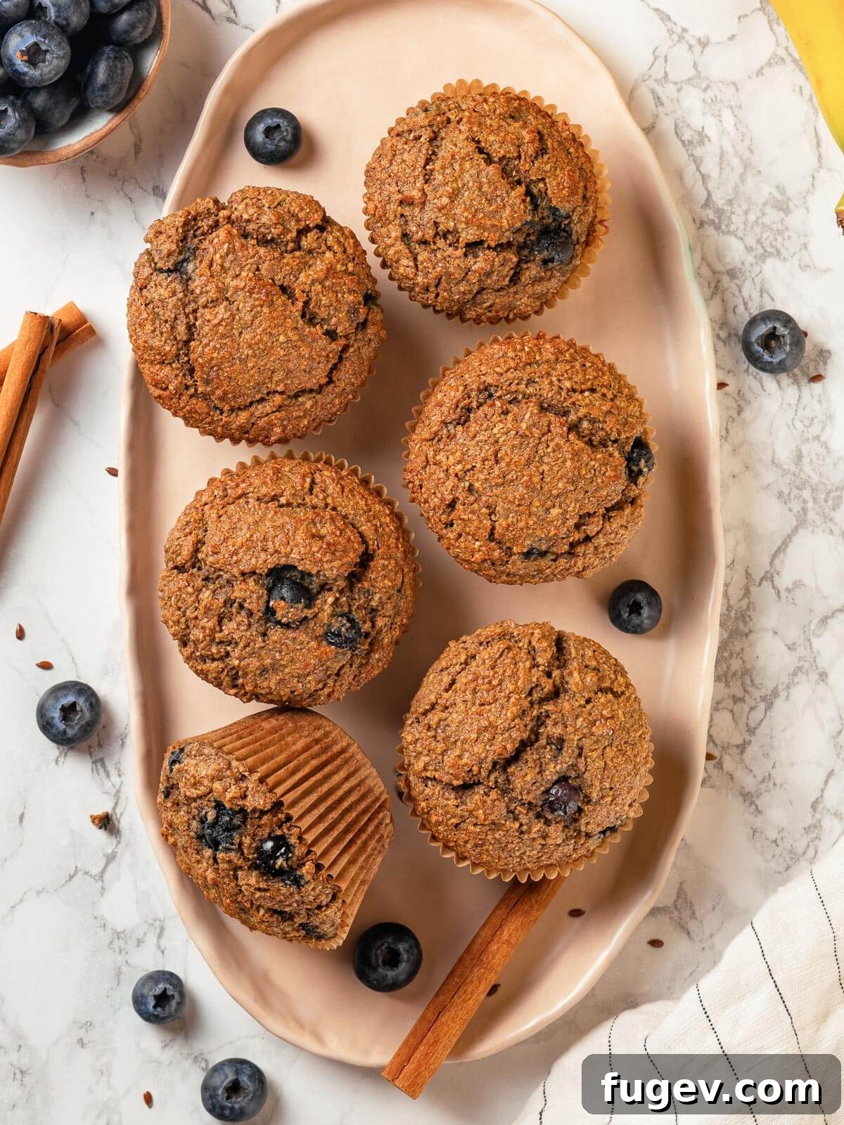 Fiber-Rich Banana Muffins 15 Finished banana bran muffins resting on a marble kitchen counter, ready to be served.