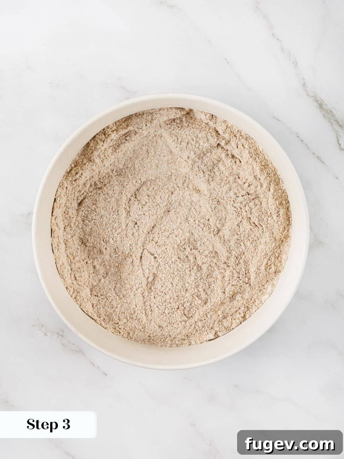 Fiber-Rich Banana Muffins 6 Whisking together dry muffin ingredients like flour, flaxseed meal, baking soda, baking powder, and cinnamon in a bowl.