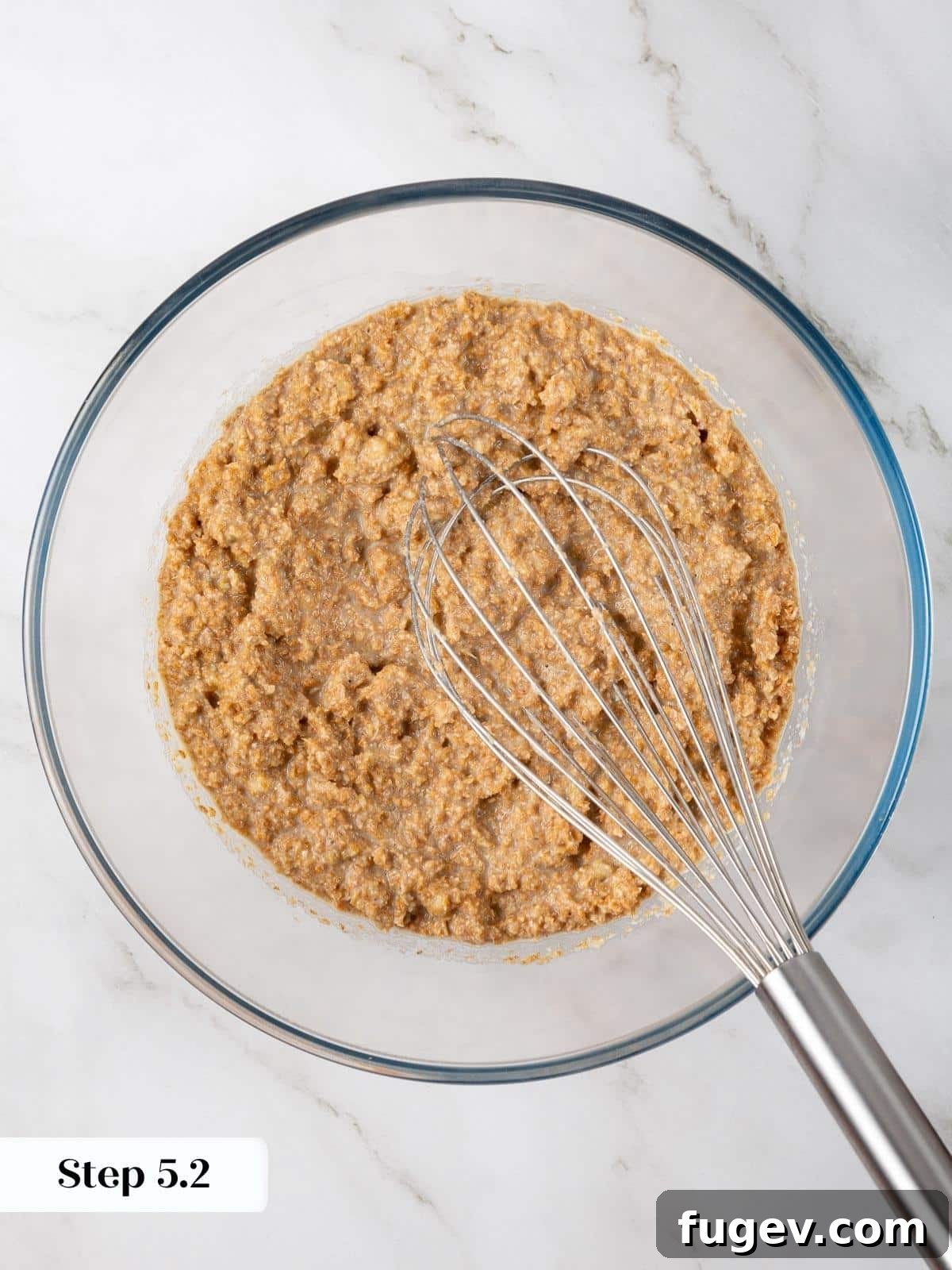 Fiber-Rich Banana Muffins 9 Wet ingredients fully mixed and smooth in a glass bowl, ready for dry ingredients.