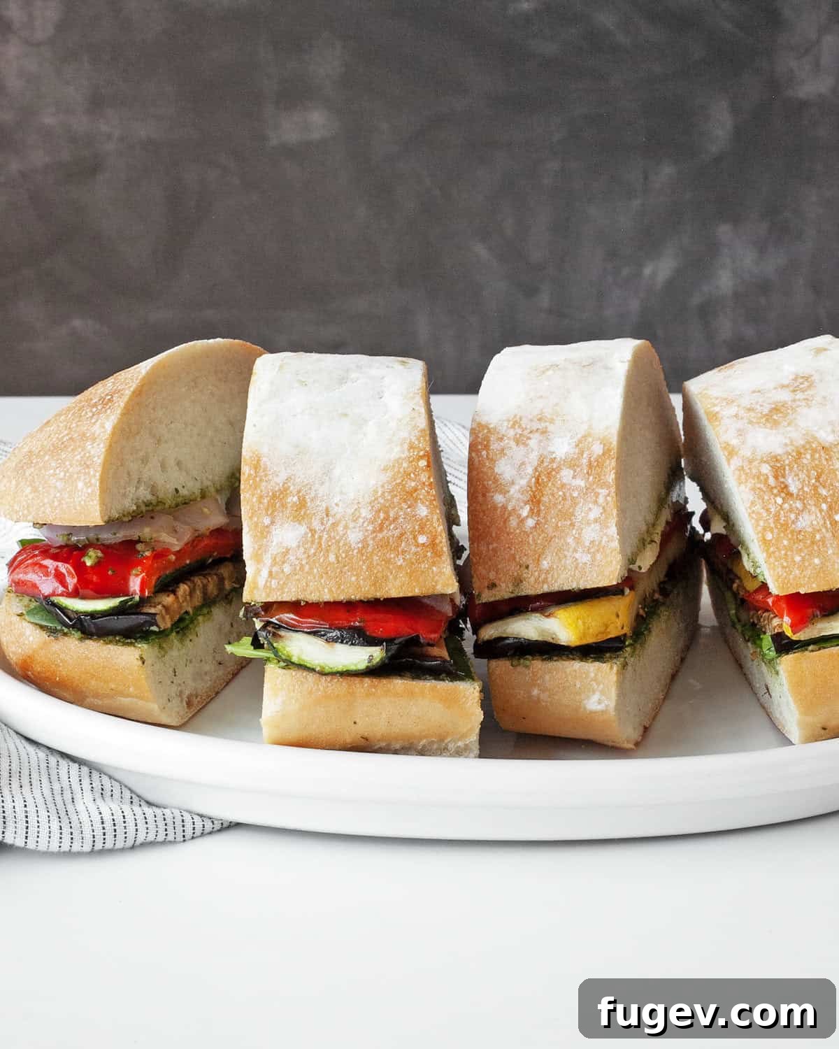 Mediterranean Grilled Vegetable Ciabatta 2 Delicious grilled vegetable ciabatta sandwiches expertly arranged on a plate, ready to be served.