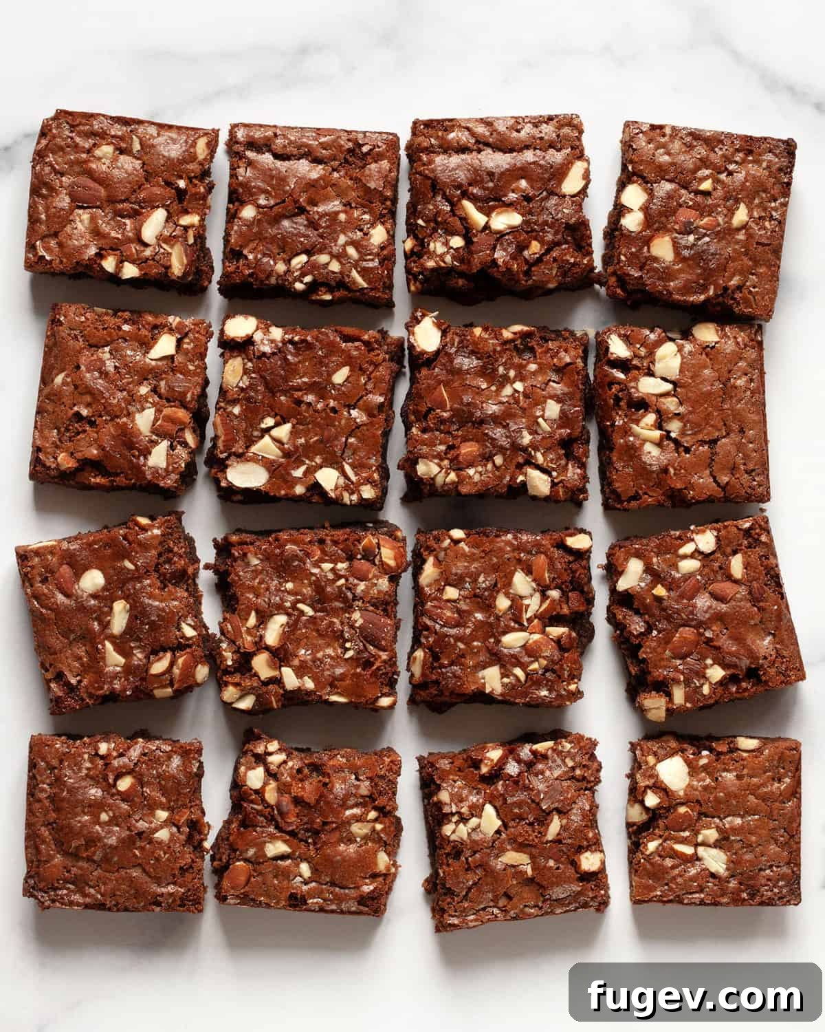 Milky Chocolate Almond Brownie Squares 2 16 fudgy milk chocolate almond brownies cut into perfect squares, arranged in 4 neat rows on a cooling rack.