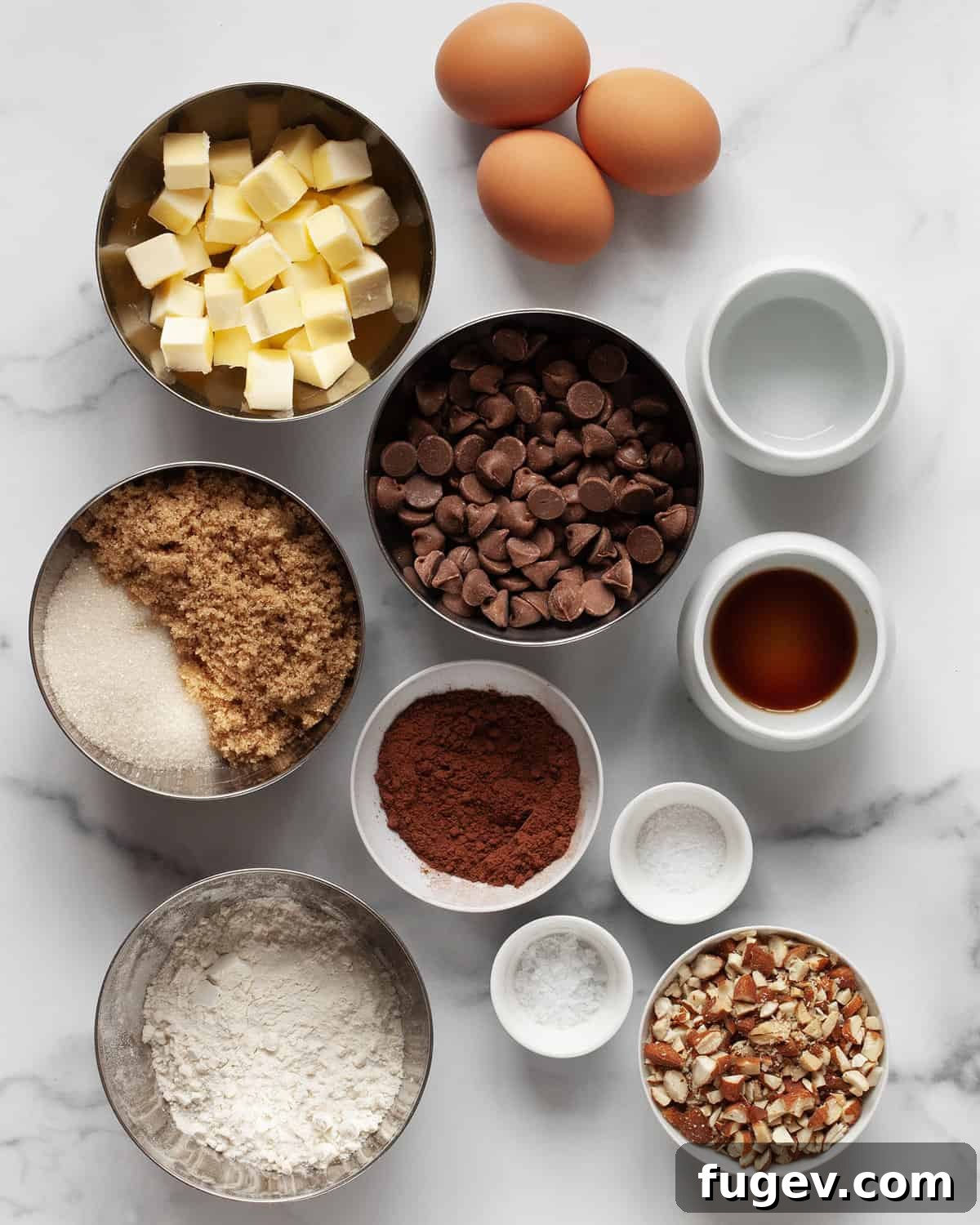Milky Chocolate Almond Brownie Squares 3 All the essential ingredients laid out for baking milk chocolate almond brownies, including butter, sugars, chocolate chips, cocoa powder, flour, salt, and eggs.