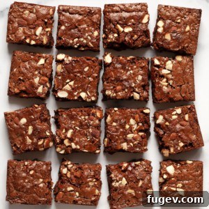Milky Chocolate Almond Brownie Squares 8 16 fudgy milk chocolate almond brownies cut into squares, arranged in 4 rows, showcasing their perfect texture and topping.