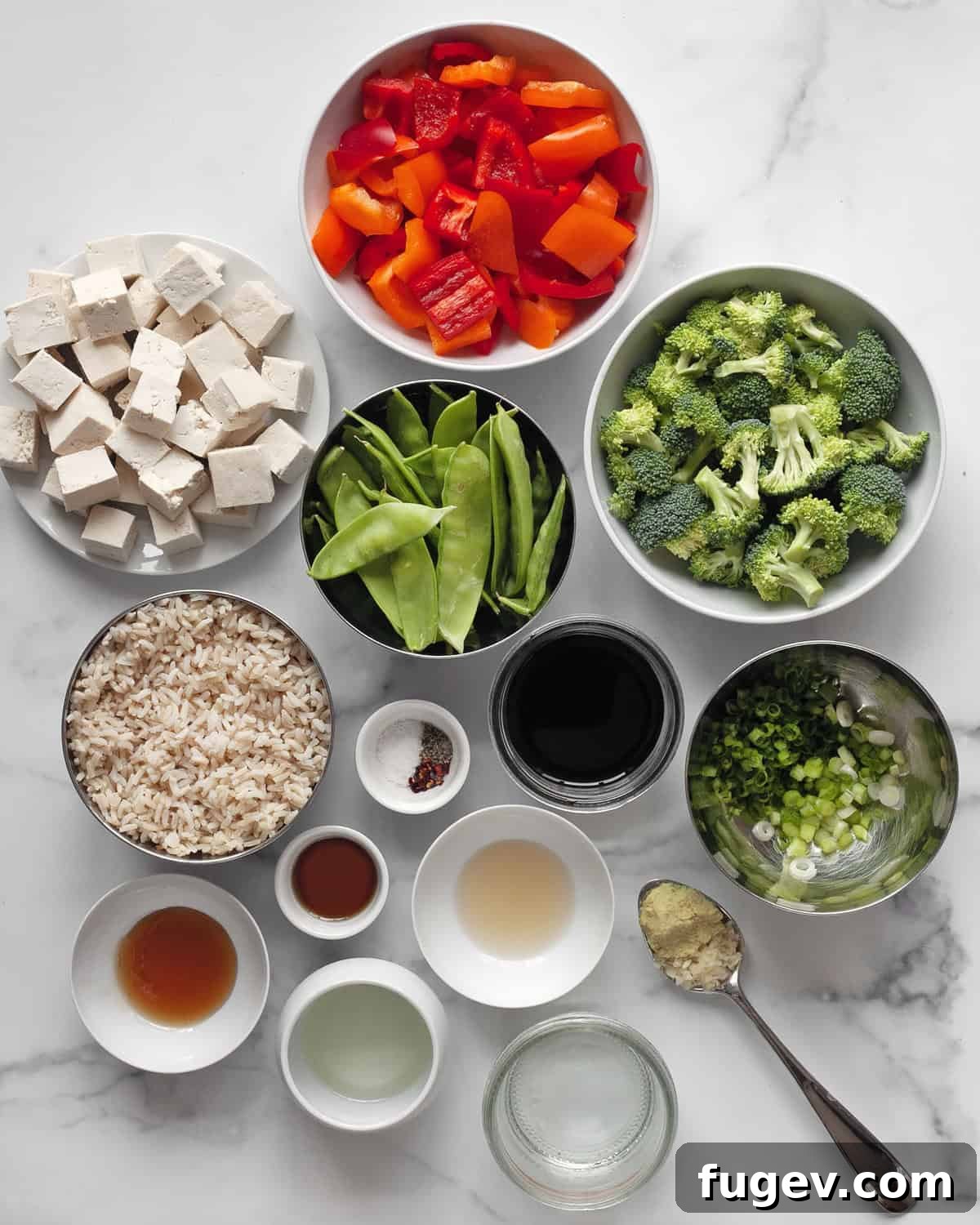 Flavorful Tofu & Veggie Medley 3 Individual ingredients laid out: rice, peppers, snow peas, broccoli, tofu, soy sauce, garlic, ginger, and oil.