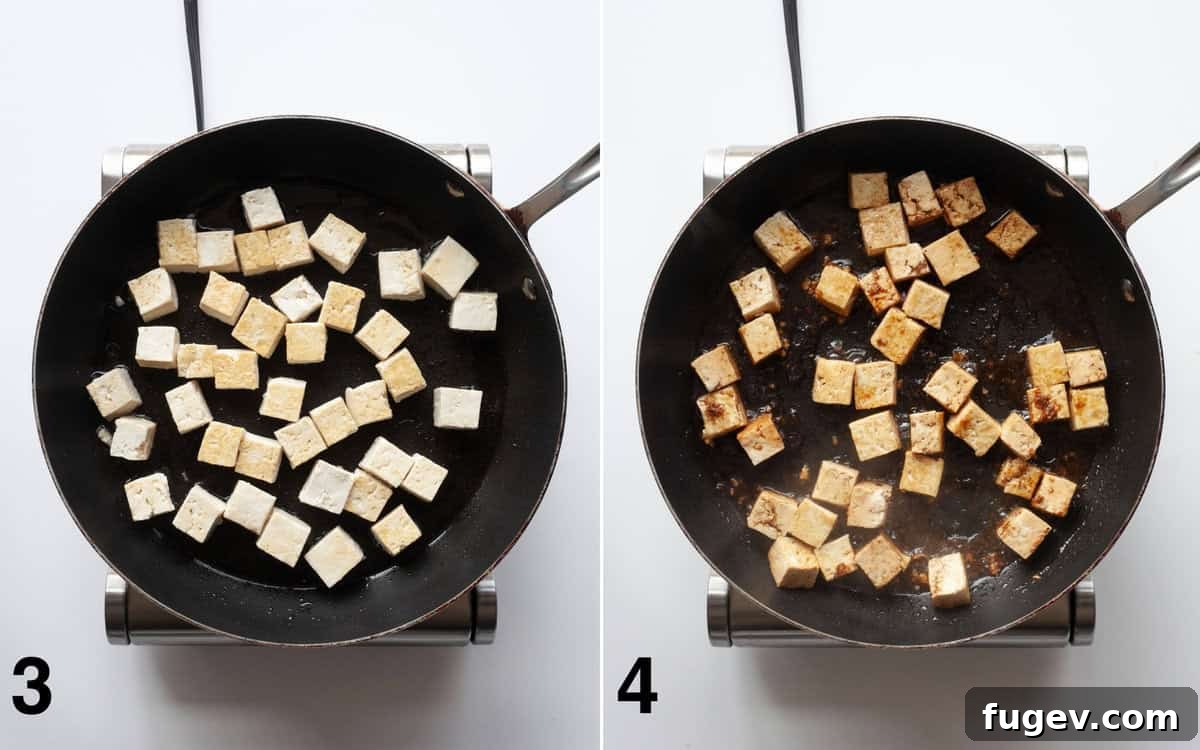 Flavorful Tofu & Veggie Medley 5 Tofu sautéing in a skillet, followed by sauce being poured over the tofu cubes.