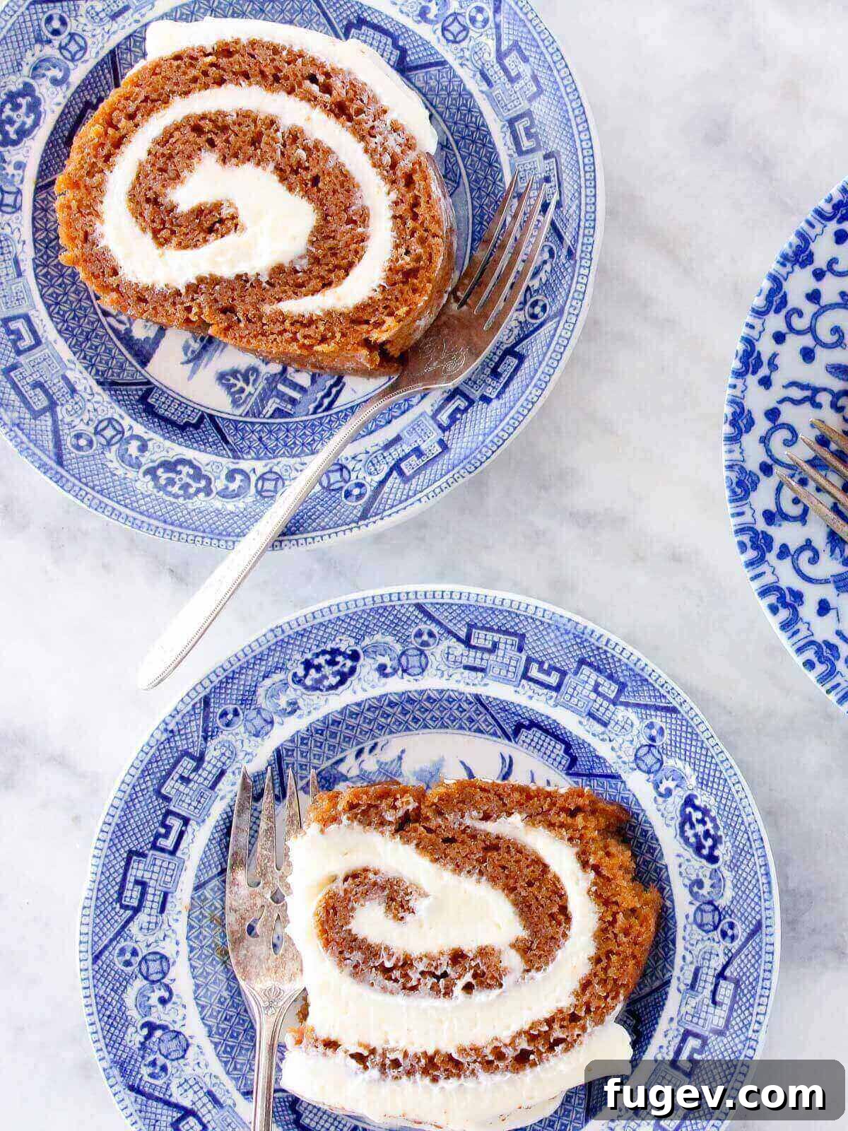 Spiced Pumpkin Roll Perfection 2 Slices of pumpkin roll served, showcasing the rich pumpkin cake and creamy filling.