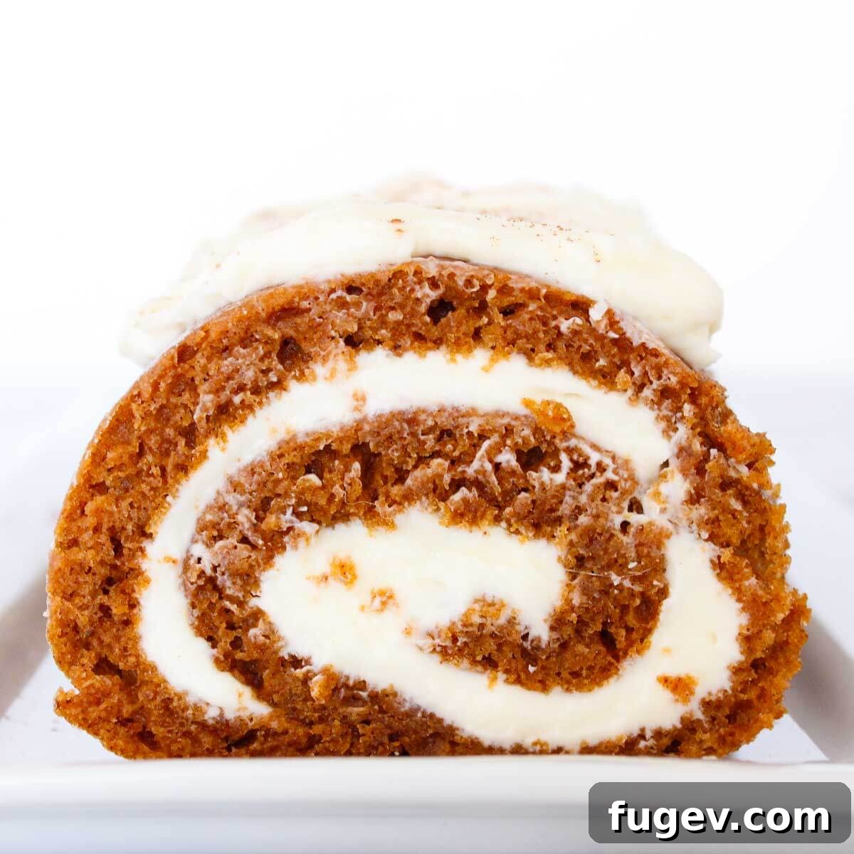 Spiced Pumpkin Roll Perfection 4 Sliced pumpkin roll showing the beautiful cream cheese filling swirl.