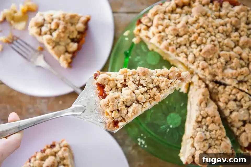 Decadent Caramel Apple Tart 5 A golden-brown Caramel Apple Tart fresh out of the oven, demonstrating its inviting warmth and delicious streusel topping.