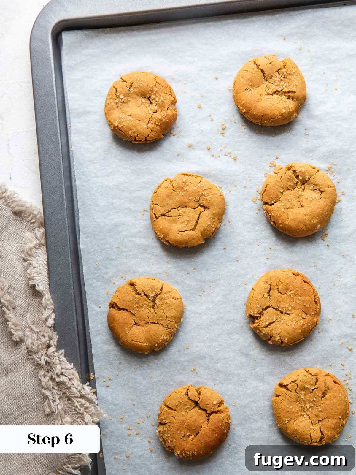 Richly Spiced Cookies 7 Freshly baked spice cookies cooling on a baking sheet with parchment paper.