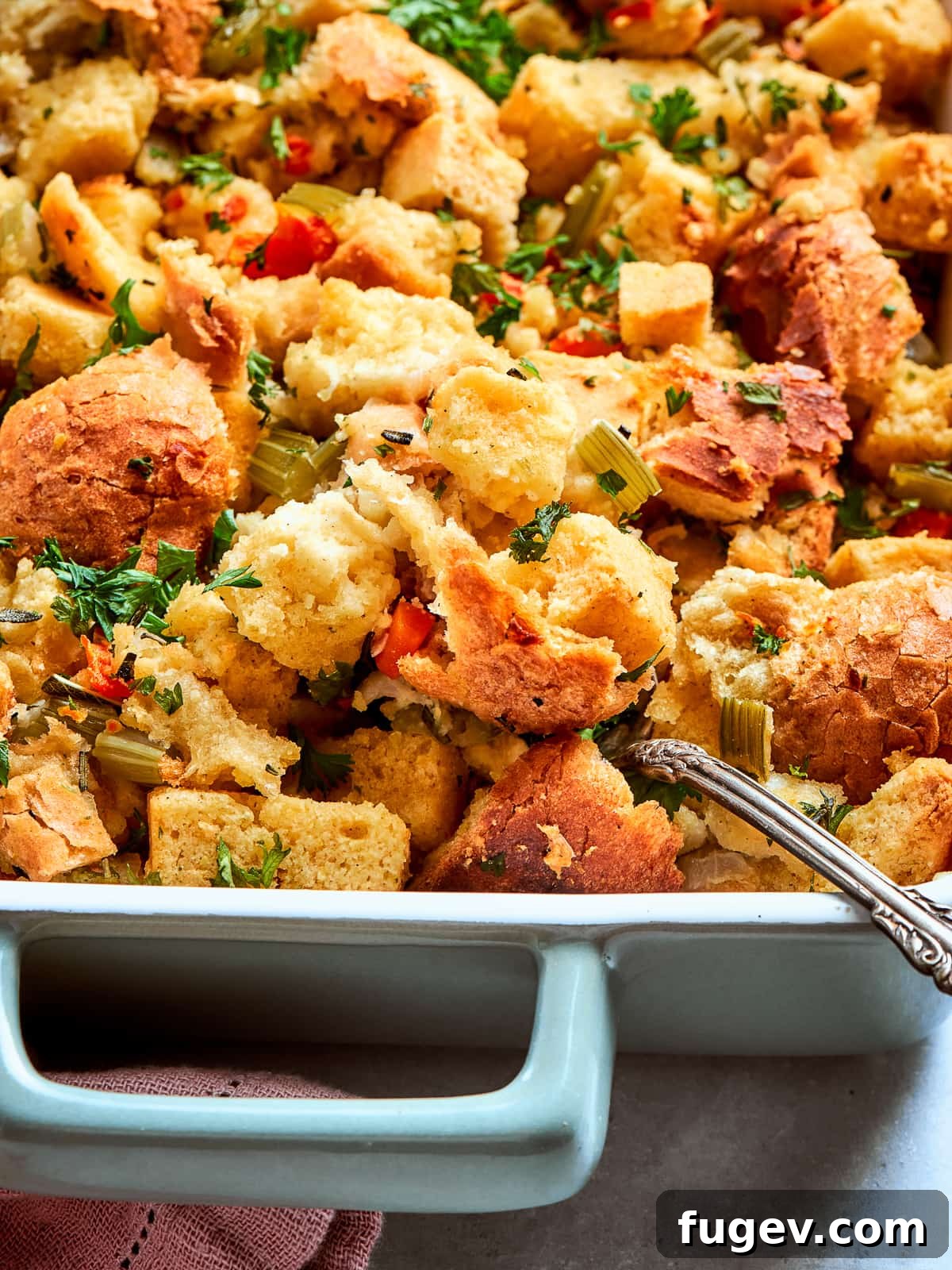 Down-Home Southern Cornbread Dressing 2 Garnished cornbread dressing topped with chopped herbs ready to serve for Thanksgiving dinner.