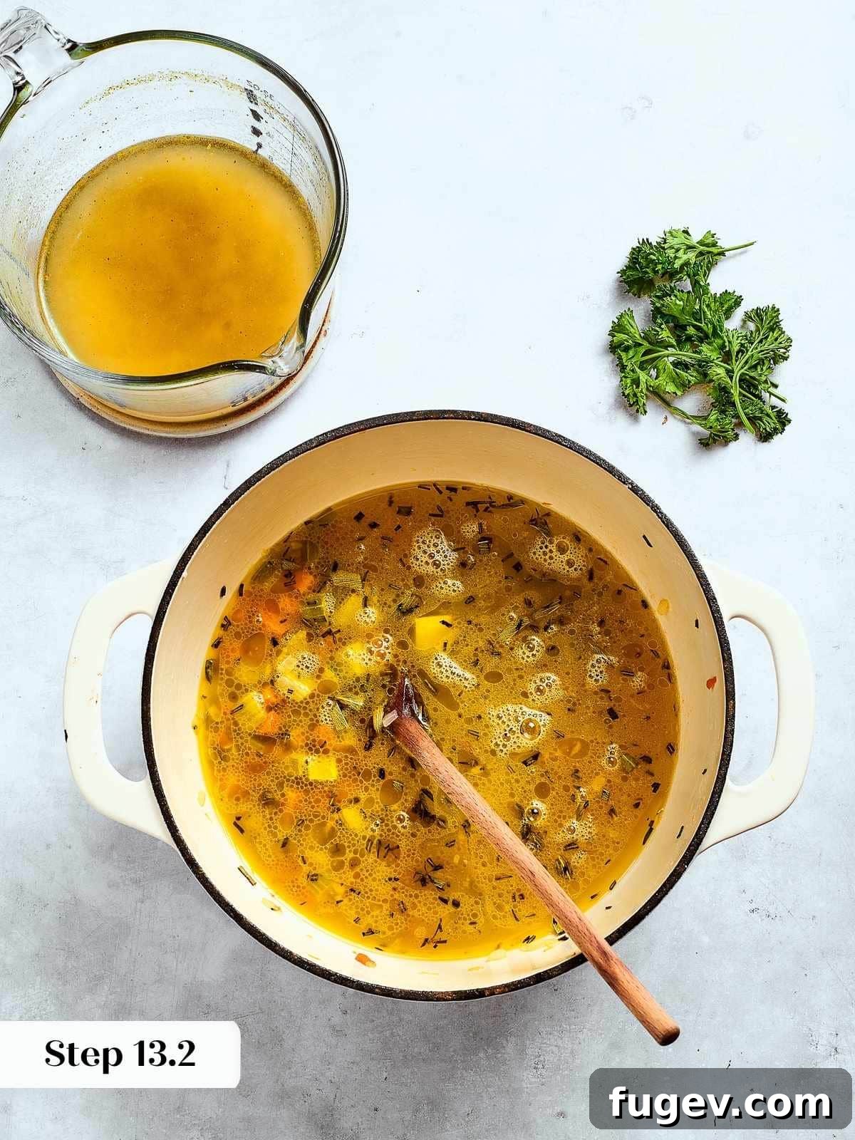 Down-Home Southern Cornbread Dressing 15 Chicken broth being poured into sautéed vegetables and herbs to build flavor for the dressing.