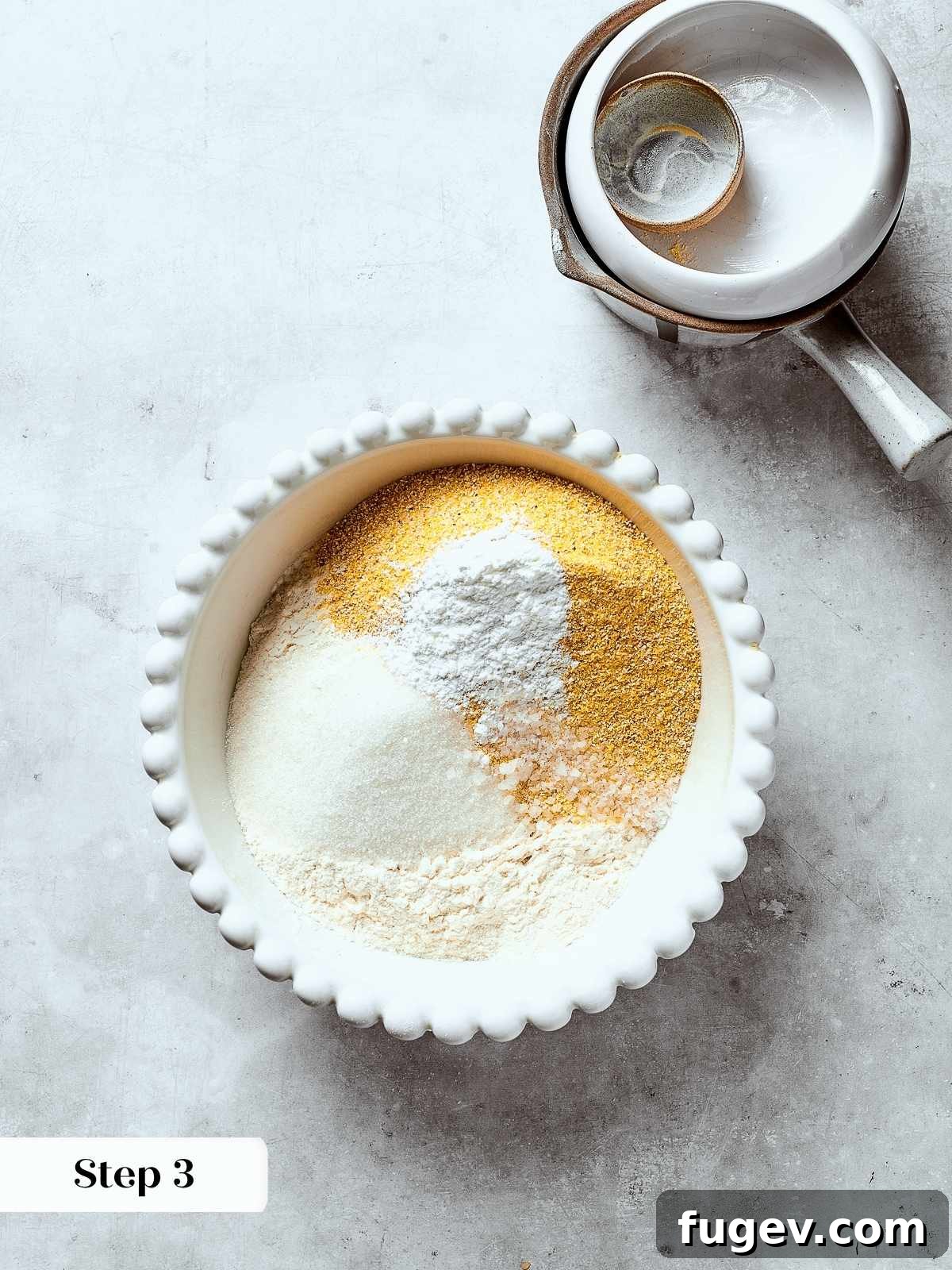 Down-Home Southern Cornbread Dressing 7 Dry ingredients including cornmeal, flour, and salt being whisked together in a large bowl.