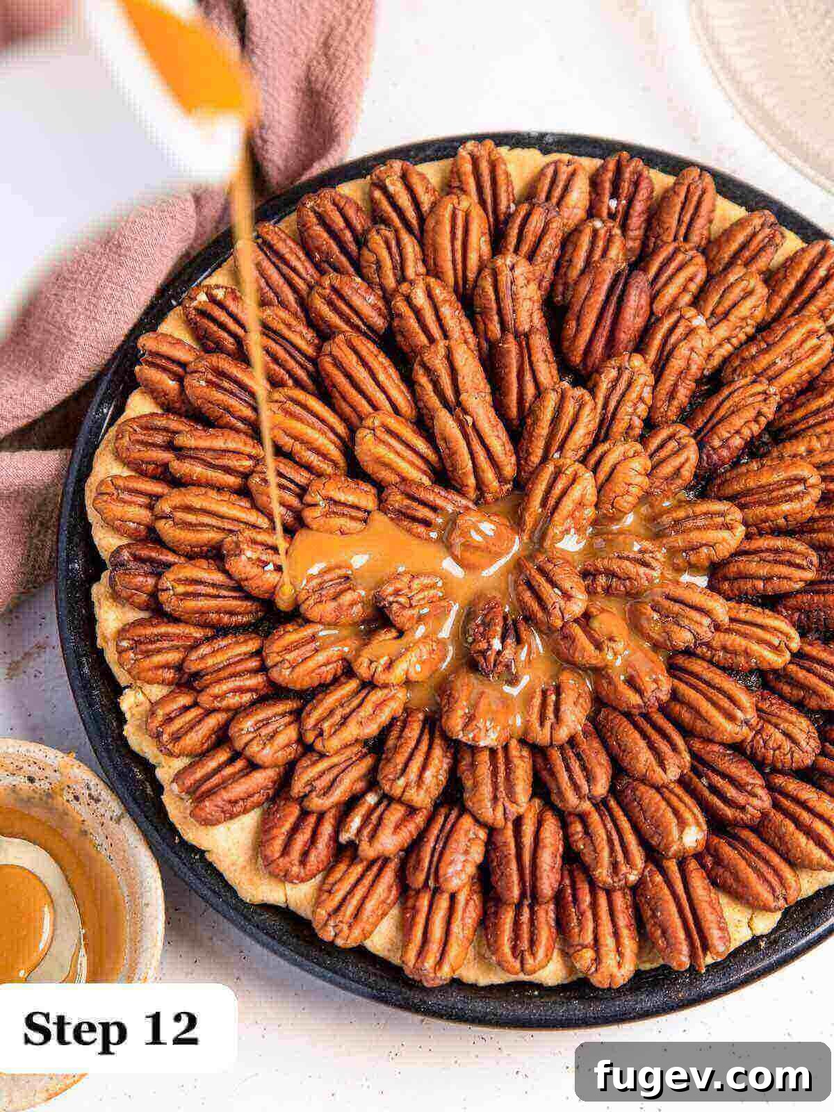 Decadent Chocolate Pecan Pie 12 Text: Step 12, a generous stream of golden salted caramel sauce being poured over a freshly baked chocolate pecan pie, beautifully coating the surface.