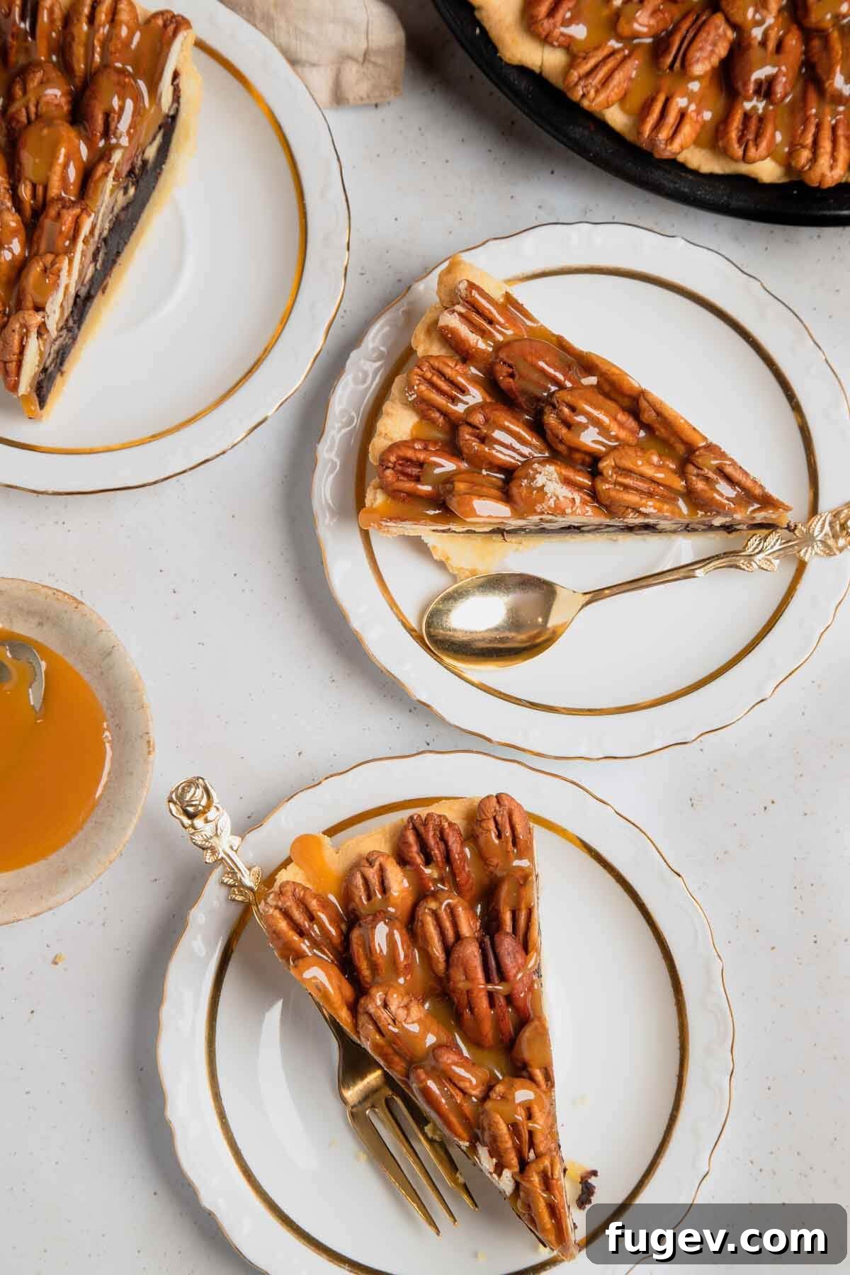 Decadent Chocolate Pecan Pie 13 Two perfect slices of chocolate pecan pie on white plates, showcasing the layered filling, crust, and caramel topping.