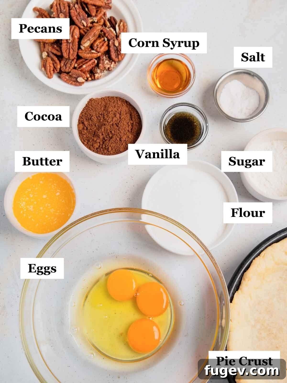 Decadent Chocolate Pecan Pie 4 Various ingredients for chocolate pecan pie neatly labeled on a countertop, including butter, cocoa, sugar, pecans, and eggs.