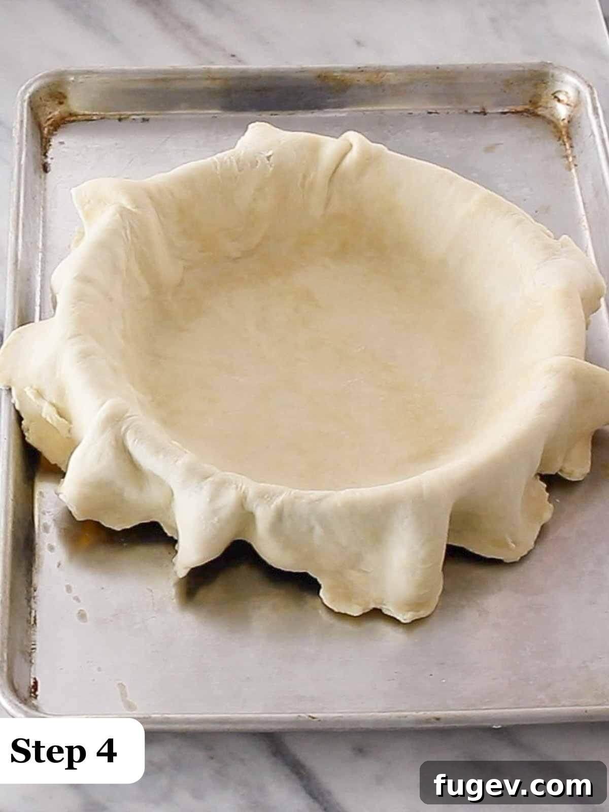 Decadent Chocolate Pecan Pie 5 Text: Step 4, a pastry chef draping pie crust over a pie tin, showing careful placement.