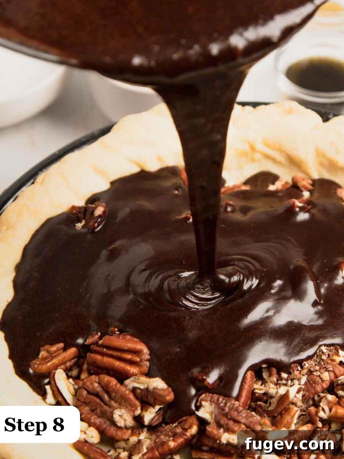 Decadent Chocolate Pecan Pie 9 Text: Step 8, a close-up of thick chocolate pecan pie filling being poured into a golden-brown, par-baked pie shell.