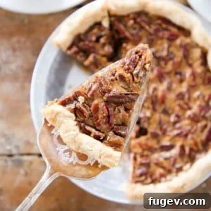 A slice of pecan pie being served, highlighting its gooey texture and nut topping.