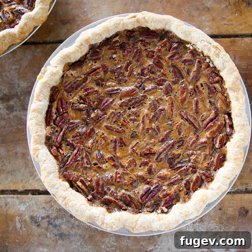 The Perfect Pecan Pie 9 A whole, unsliced classic pecan pie, showcasing its beautifully browned crust and rich pecan topping.