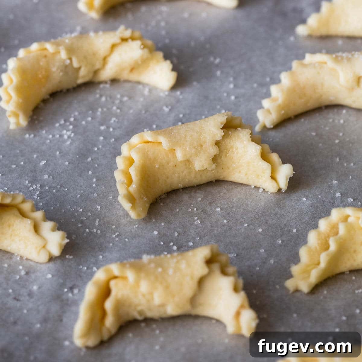 Hungarian Walnut Roll Cookies 13 nut roll cookies on baking sheet.