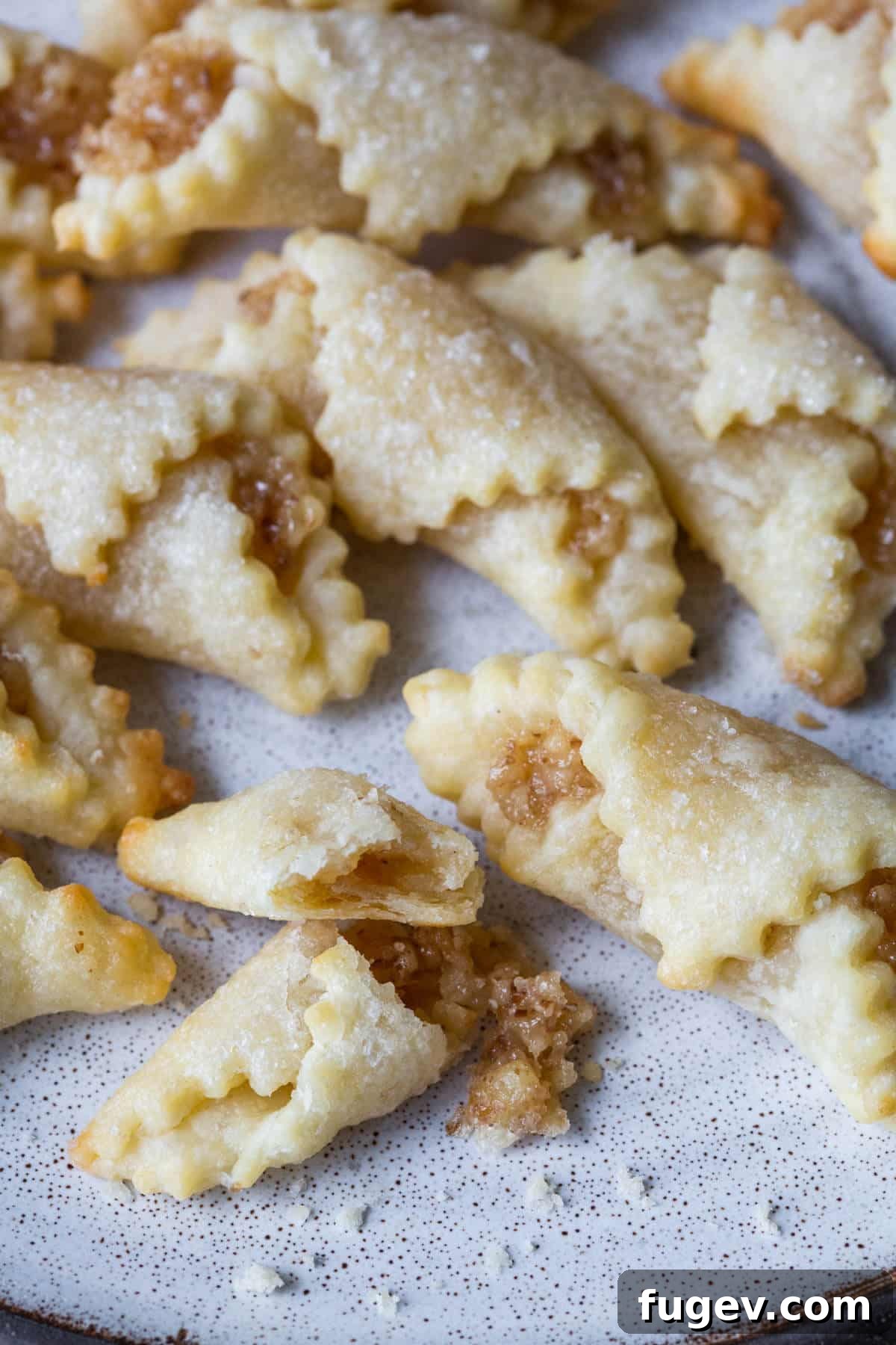 Hungarian Walnut Roll Cookies 4 nut roll cookies broken open on plate.