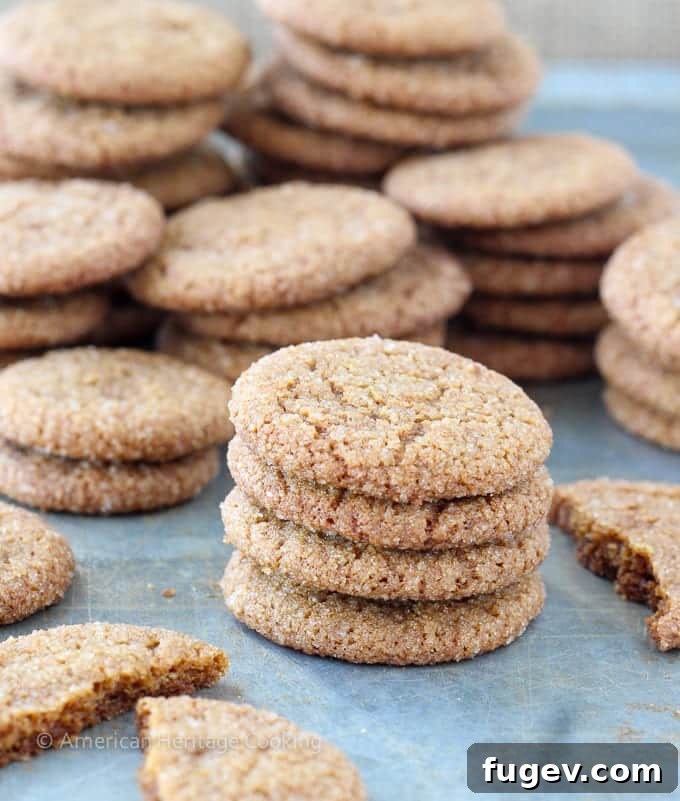 Timeless Gingersnap Cookies 7 A freshly baked gingersnap, showcasing its perfectly cracked top and golden-brown color.