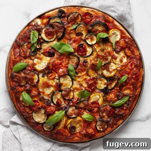 Roasted veggie pizza, sliced and ready to serve.