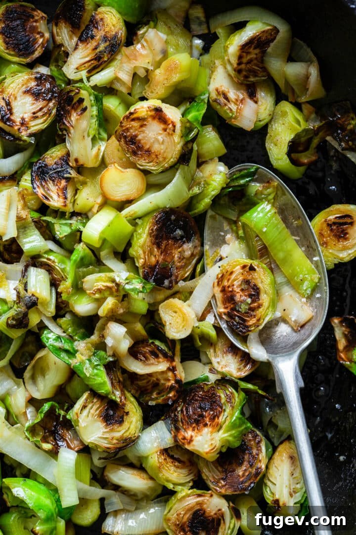 Zesty Lime Ginger Brussels Sprouts and Leeks 7 Close-up of a spoonful of Roasted Brussels Sprouts and Leeks with Lime-Ginger Butter, highlighting the caramelized texture.