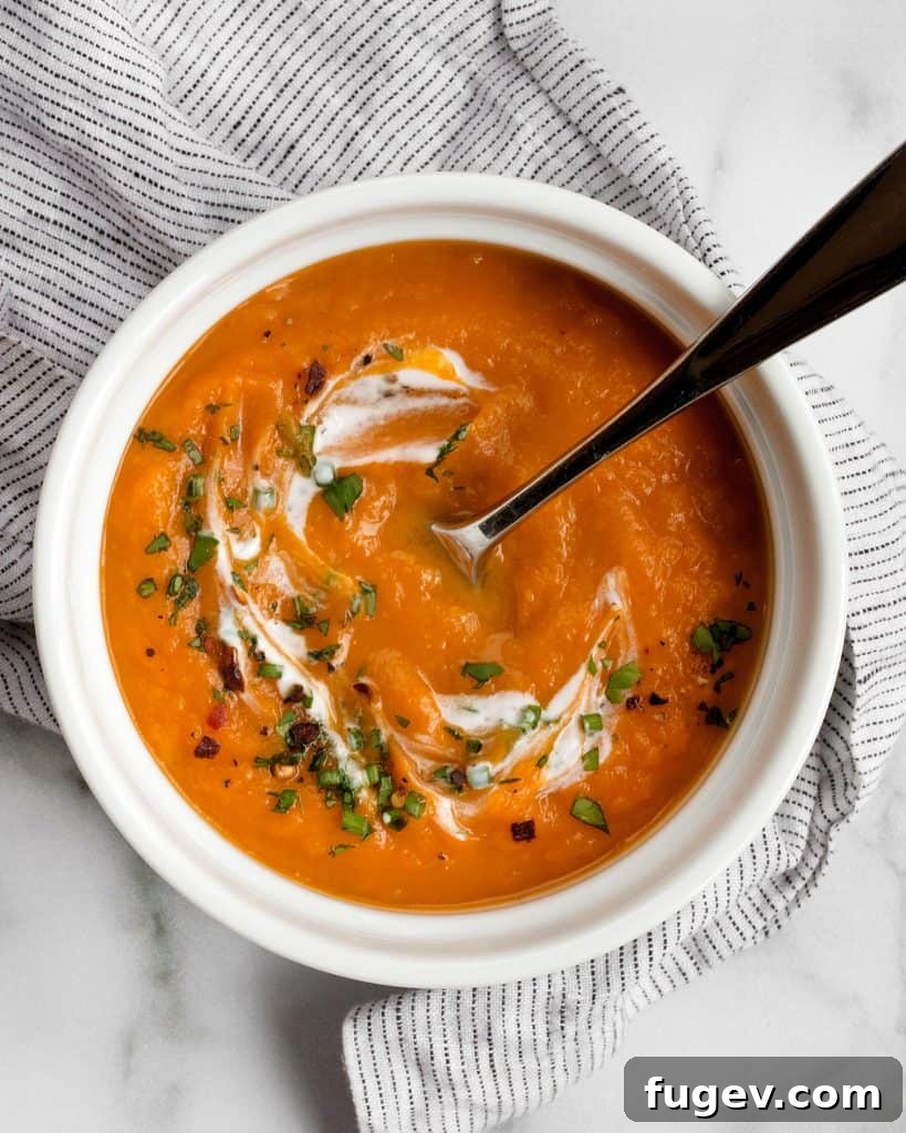 Velvety Sweet Potato Soup 3 Close-up of creamy Sweet Potato Soup in a bowl with a spoon