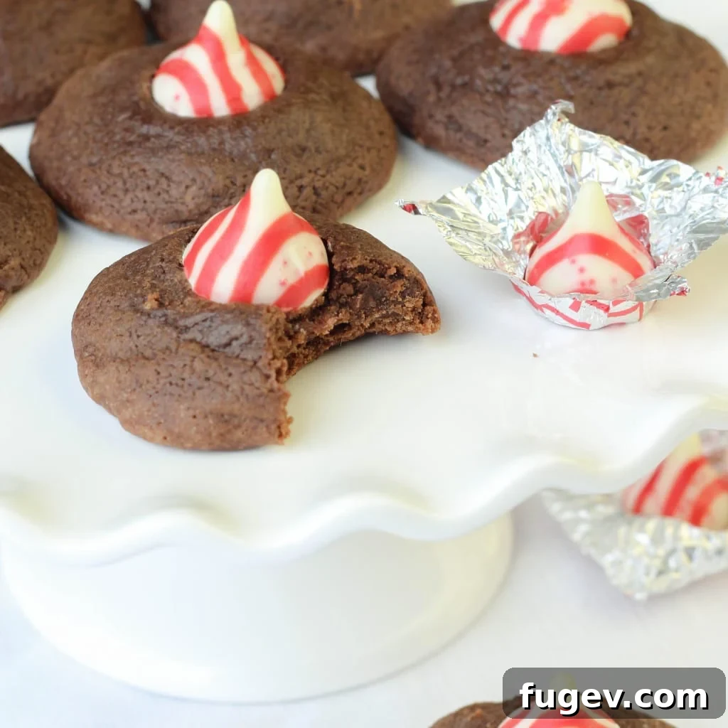 Rich Peppermint Chocolate Kisses 4 A Double Chocolate Peppermint Kiss Cookie with a bite taken out, showing the soft, fudgy interior