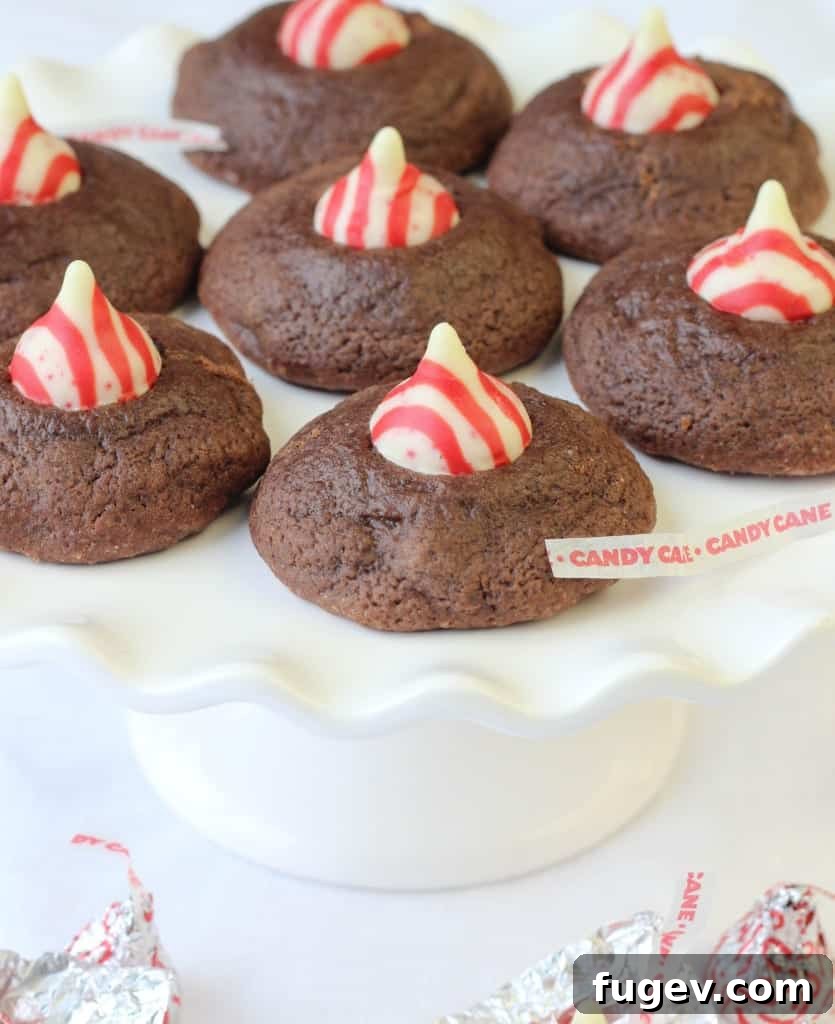 Rich Peppermint Chocolate Kisses 7 A baking sheet filled with Double Chocolate Peppermint Kiss Cookie dough balls, ready for the oven