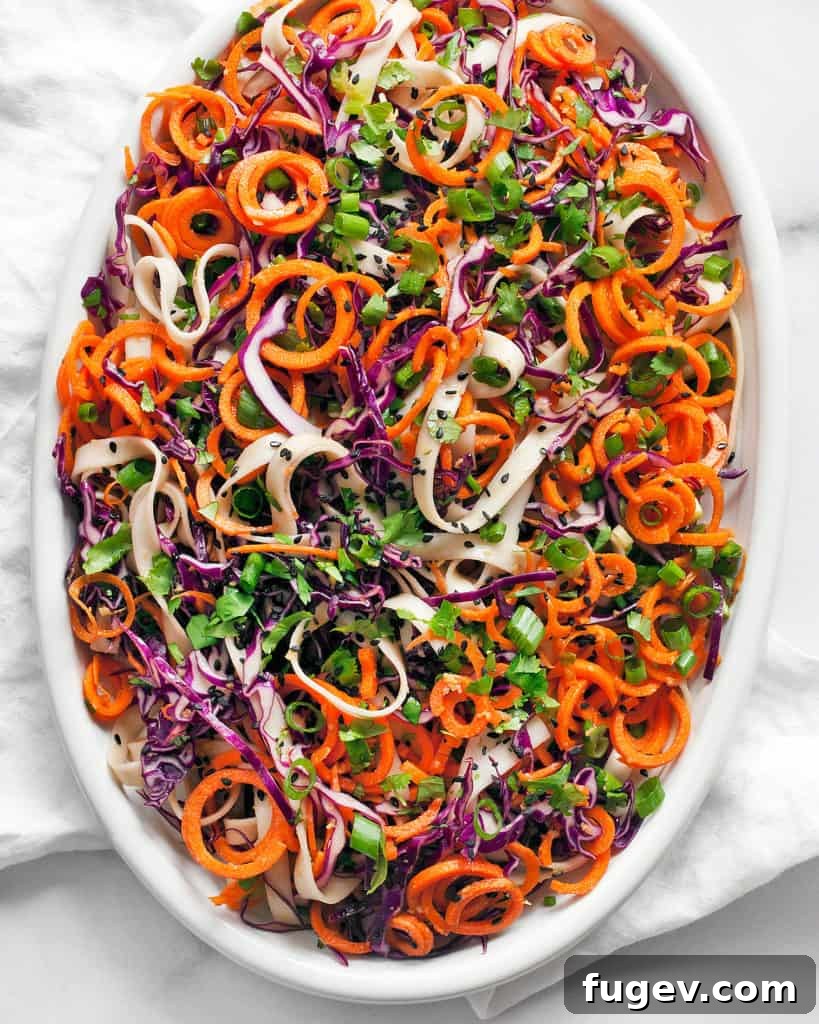 Zesty Sesame Ginger Noodles 3 Overhead shot of Sesame Ginger Noodles in a bowl, surrounded by fresh ingredients.