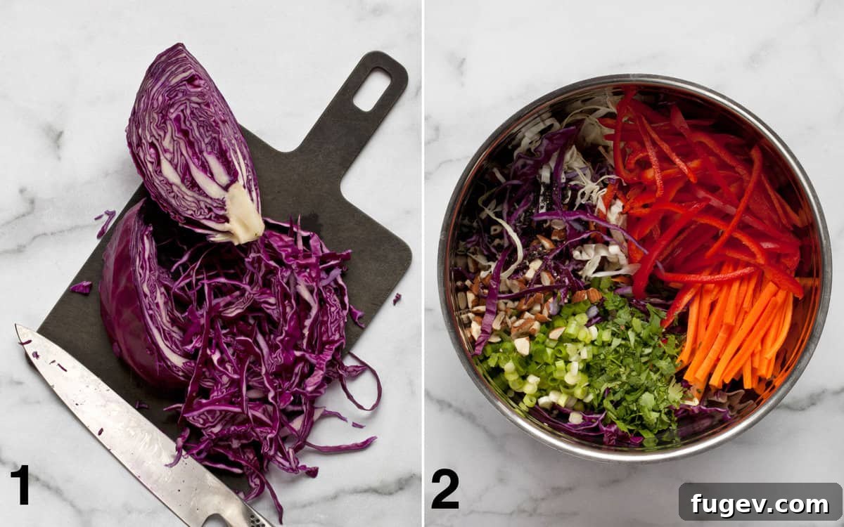 Vibrant Asian Slaw 4 A cutting board with freshly shredded cabbage, next to a large bowl filled with various colorful, undressed salad ingredients like carrots, peppers, and cilantro.