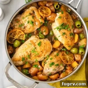 Cooked lemon chicken before serving, showcasing its golden hue and tender texture, garnished with fresh herbs.