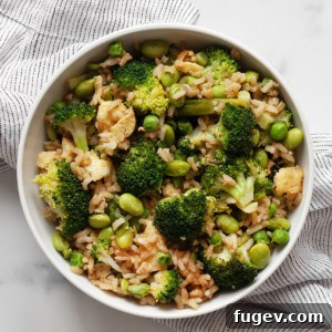 Broccoli fried rice in a bowl, garnished with fresh scallions.