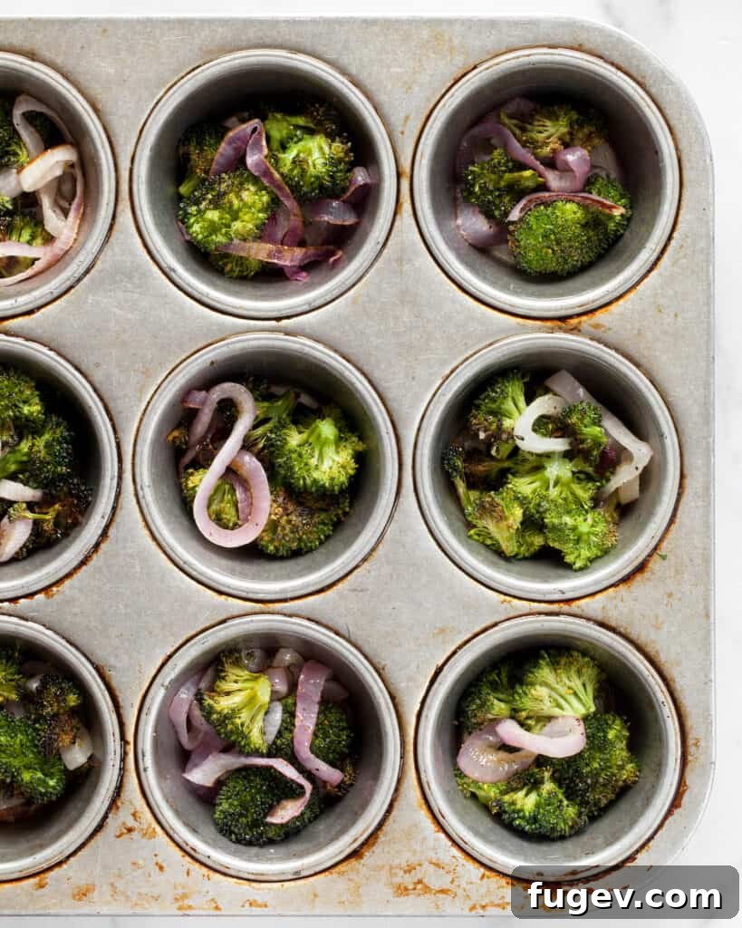 Roasted Broccoli and Caramelized Onion Egg Bites 8 Divide the roasted broccoli and onion into muffin cups