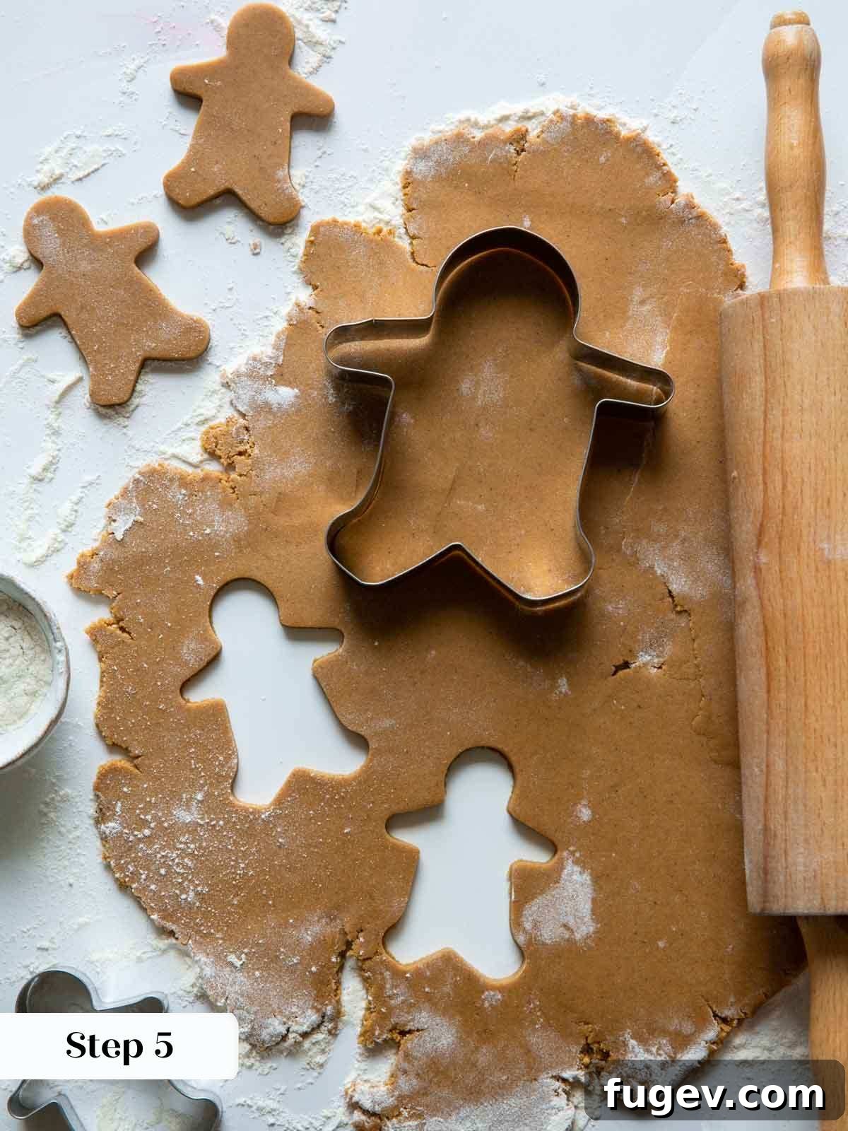 Melt-in-Your-Mouth Gingerbread Treats 7 Gingerbread dough being rolled and cut with cookie cutters.