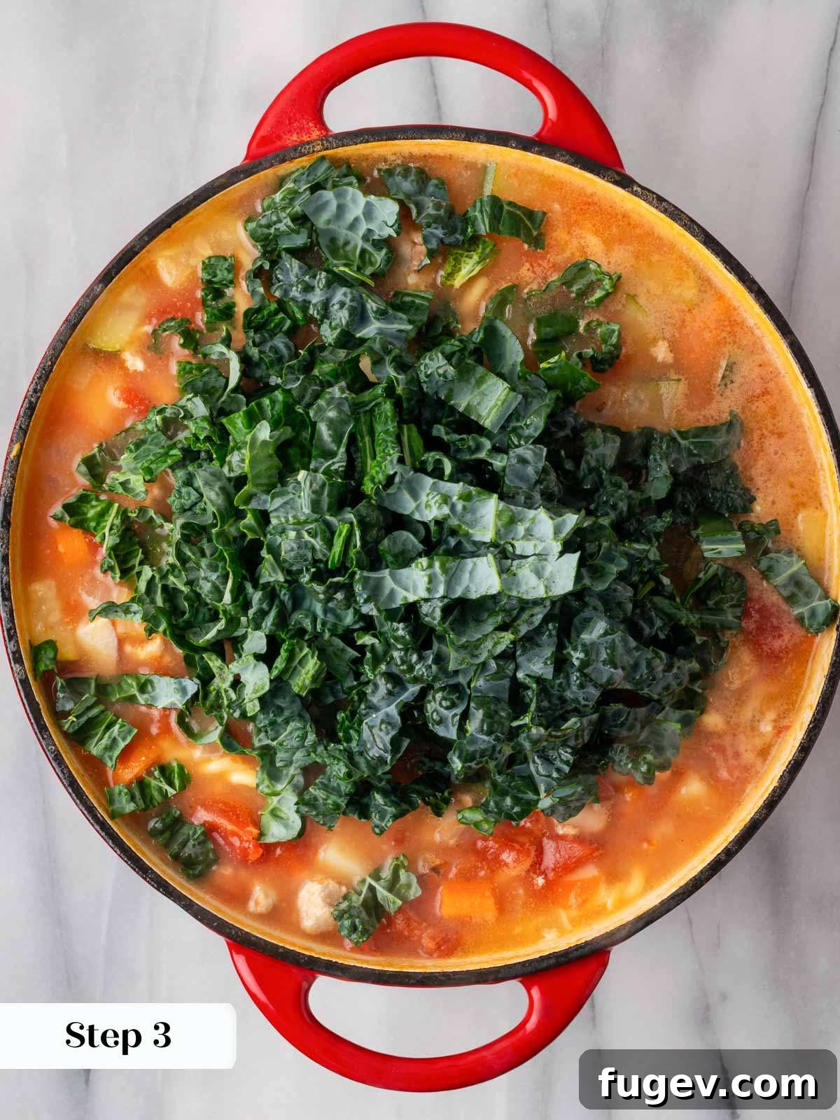 Wholesome Ground Turkey Soup 7 Fresh kale being stirred into the simmering ground turkey and vegetable soup, adding color and nutrients.