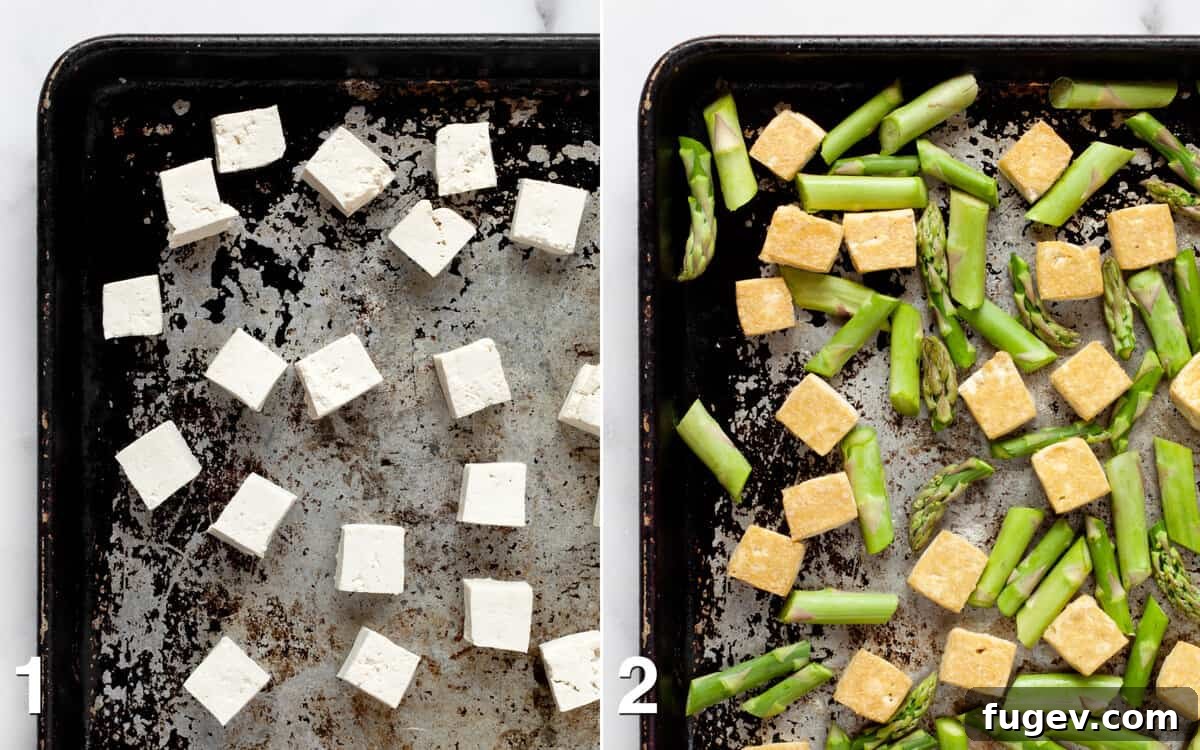 Crispy Sesame Tofu and Roasted Asparagus Sheet Pan Dinner 4 Tofu cubes baking on a sheet pan, followed by asparagus being added to the same pan for co-roasting.