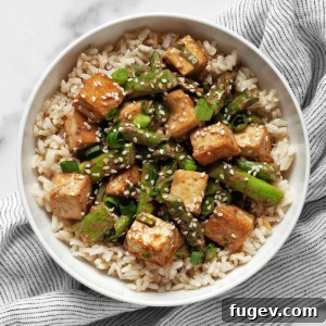 Crispy Sesame Tofu and Roasted Asparagus Sheet Pan Dinner 7 Sesame tofu and asparagus with brown rice in a bowl.
