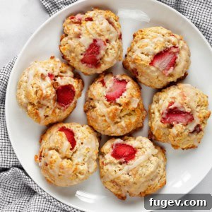 Beautifully baked strawberry almond scones arranged on a serving plate, ready to be enjoyed.