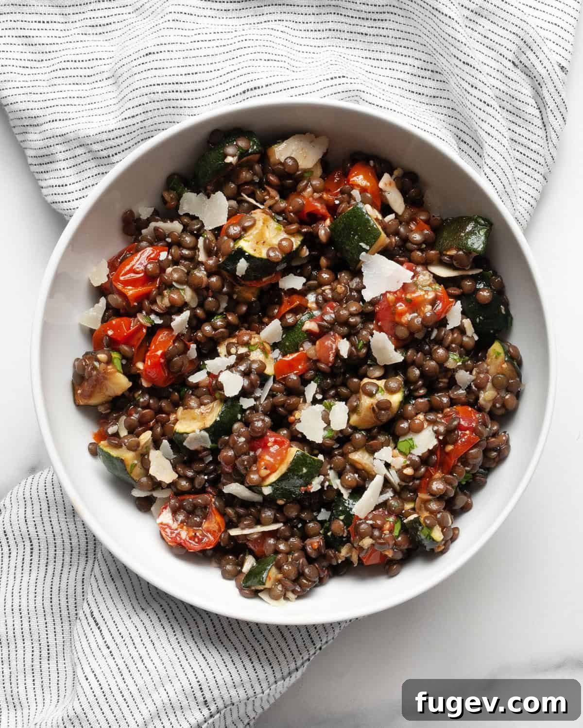 Vibrant Roasted Zucchini Tomato Lentil Salad 7 A bowl of roasted lentil salad featuring vibrant roasted zucchini and tomatoes, ready to be enjoyed.