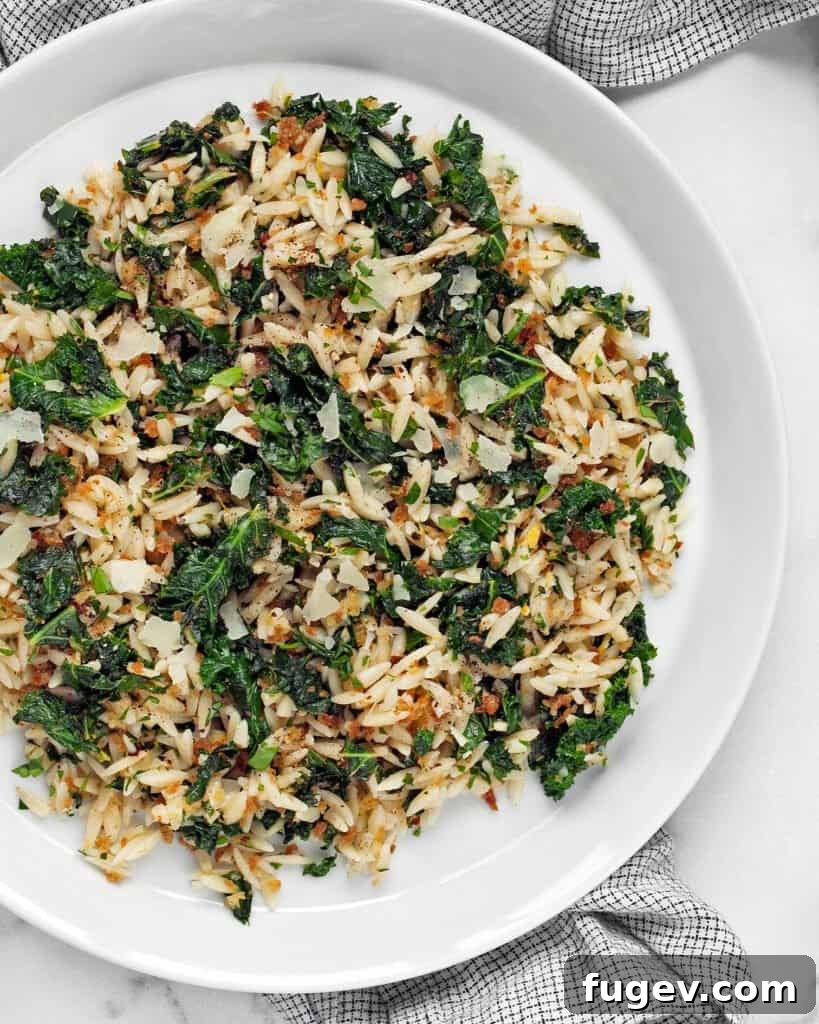 Zesty Lemon Kale Orzo 2 A close-up shot of a vibrant Lemon Kale Orzo dish, featuring rice-shaped pasta, sautéed kale, and hints of lemon zest, ready to be served.